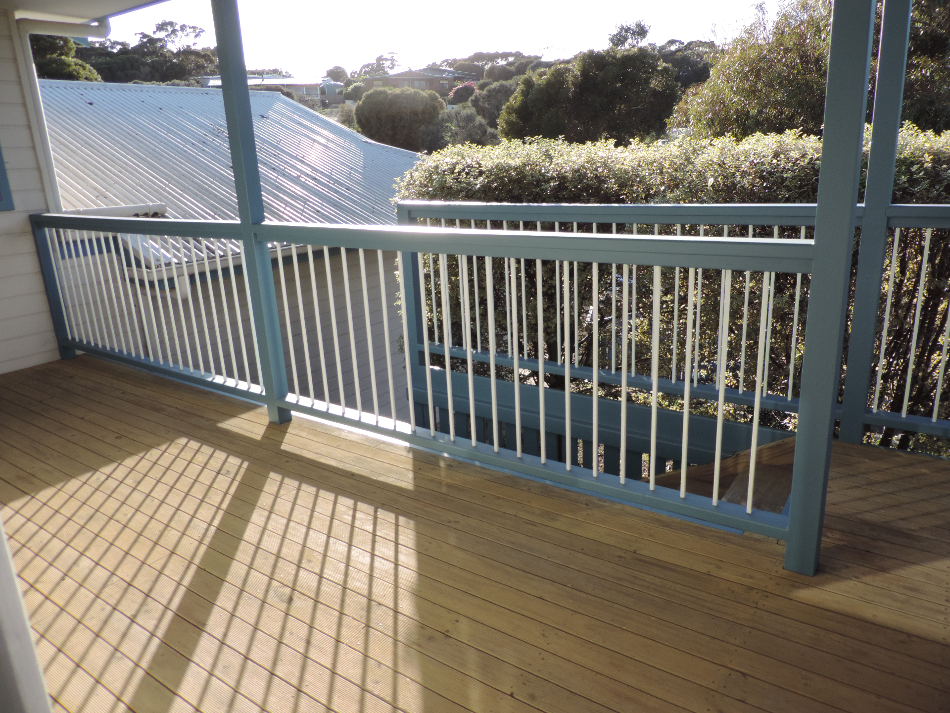 Neat painted railing and deck area in afternoon light